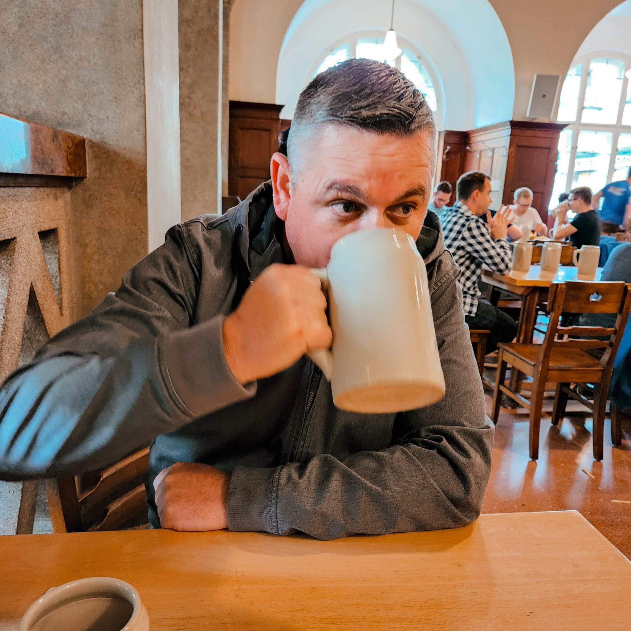 mike drinking his beer at the beer house in Salzburg