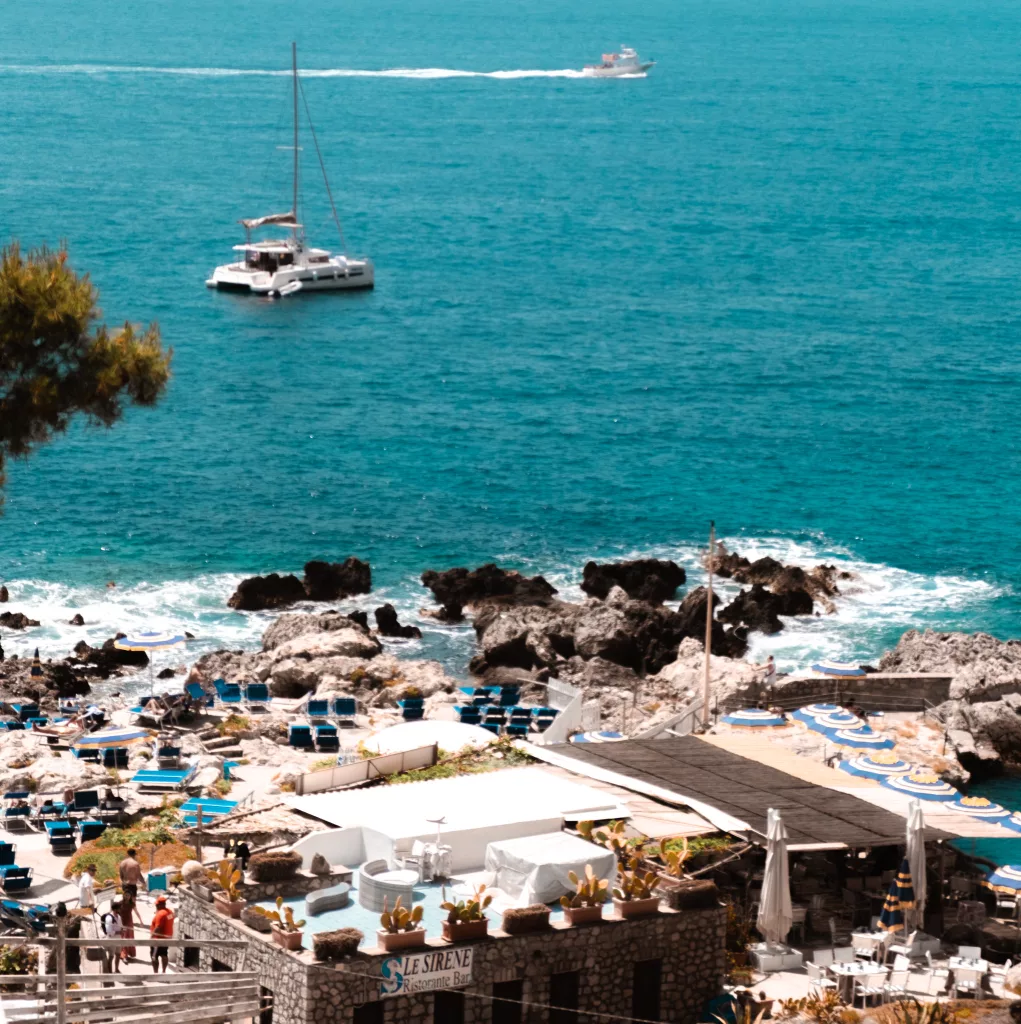 Marina Piccola Beach Capri italy. Boats in the water and sun umbrellas out