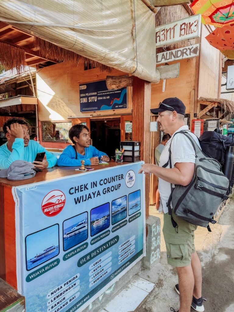 buying our boat tickets to Bali while on Gili Air