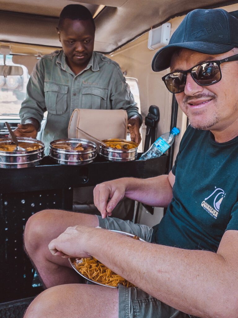 Our guide serves us a picnic in our safari jeep while watching the great migration!