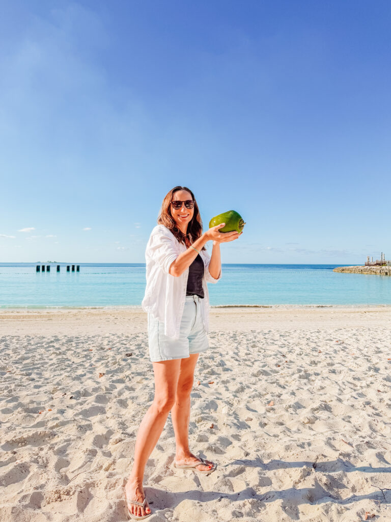 kelly with coconut on the lighthouse beach on ocean cay bahamas
