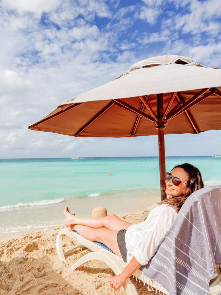 kelly soaking up the clearest water at dominicus beach, bayahibe, dominican republic