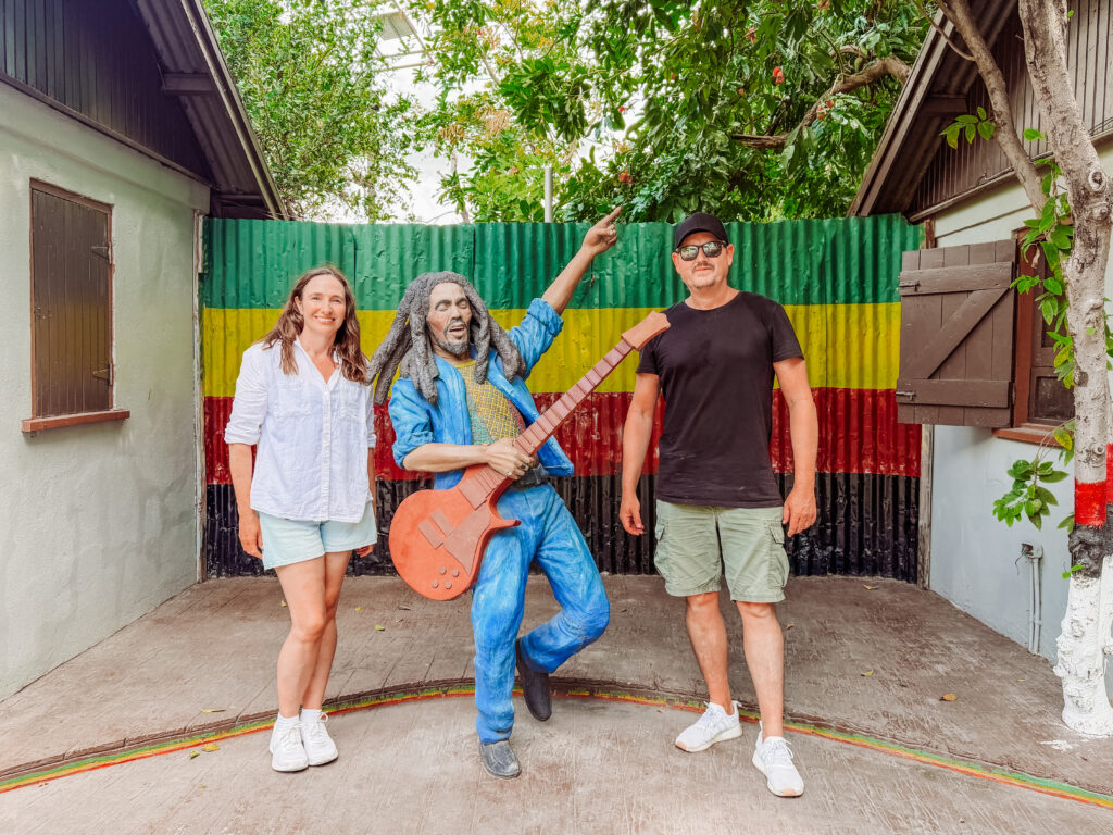 mike and kelly with the bob marley statue at the cultre yard