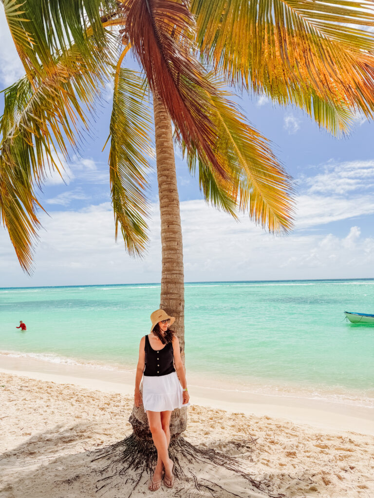 kelly under a palm tree on saona island in the dominican republic