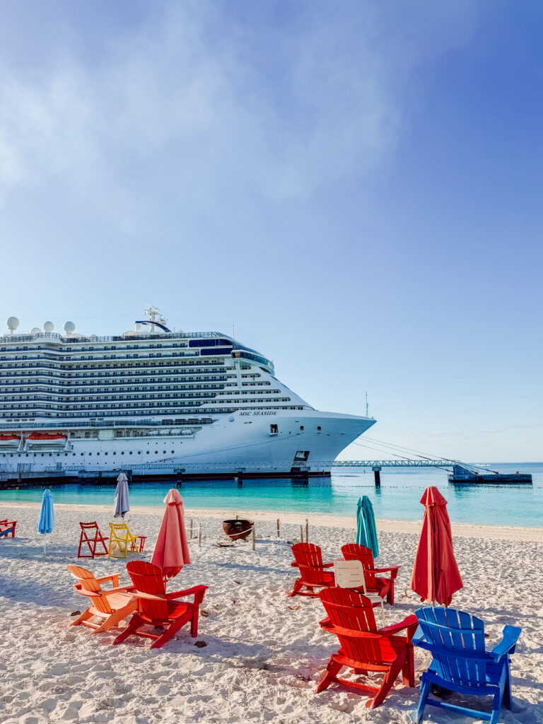 the msc cruise ship is right next to ocean cays light house beach in bahamas