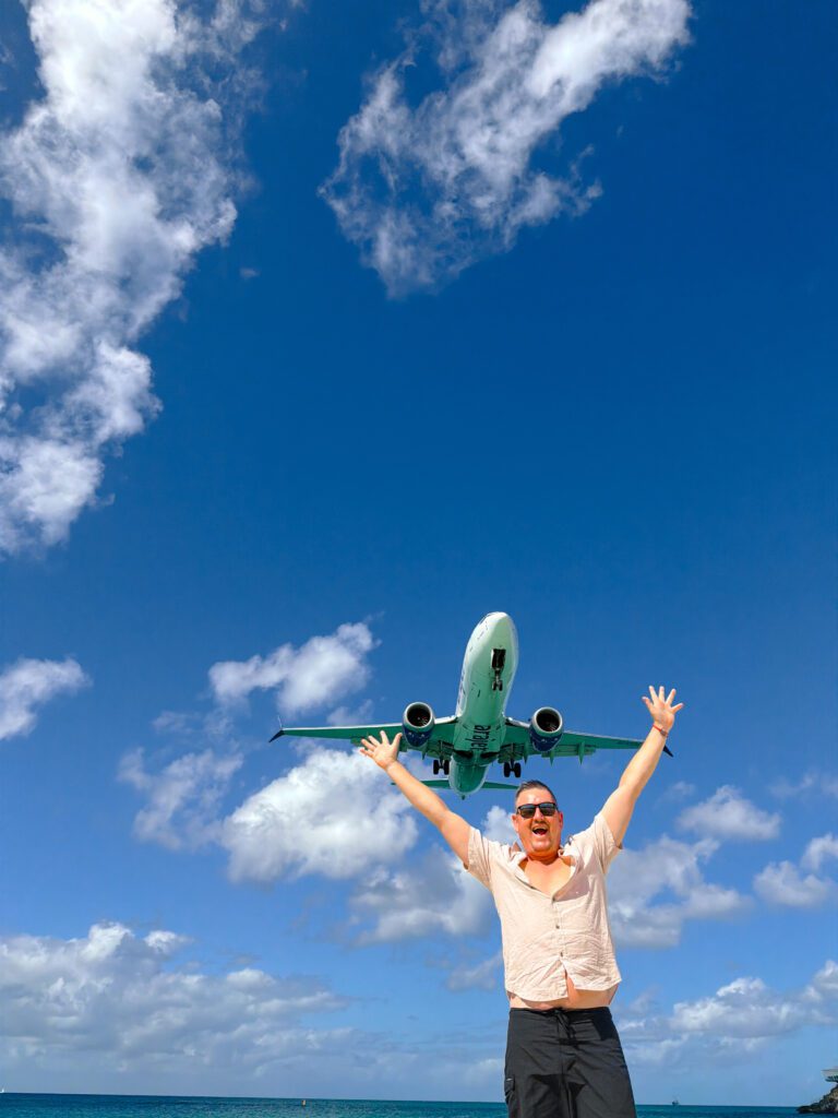 mike on maho beach st maarten while planes land over head