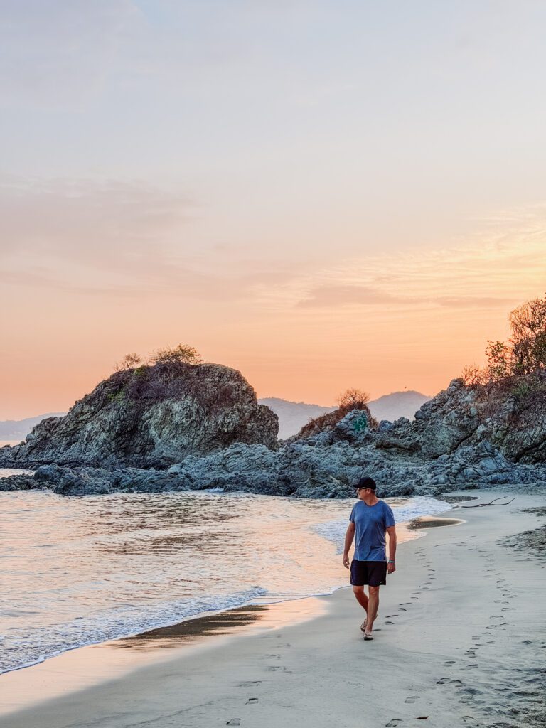 mike walking the beach at sunrise over sayulita at playa de los muertos sayulita mexico
