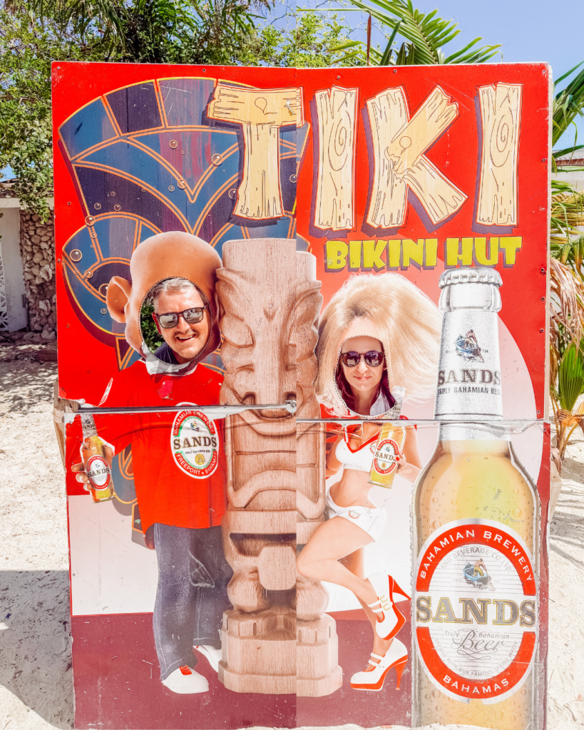 kelly and mike in a tiki picture booth