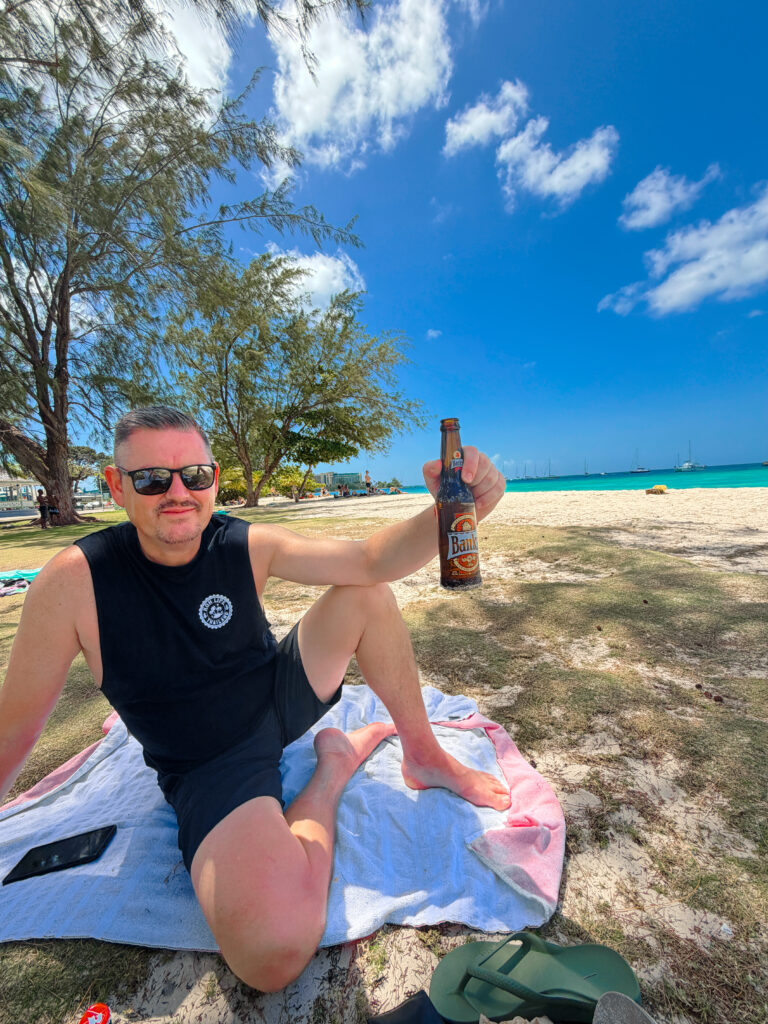 mike enjoying a beer on the beach barbados