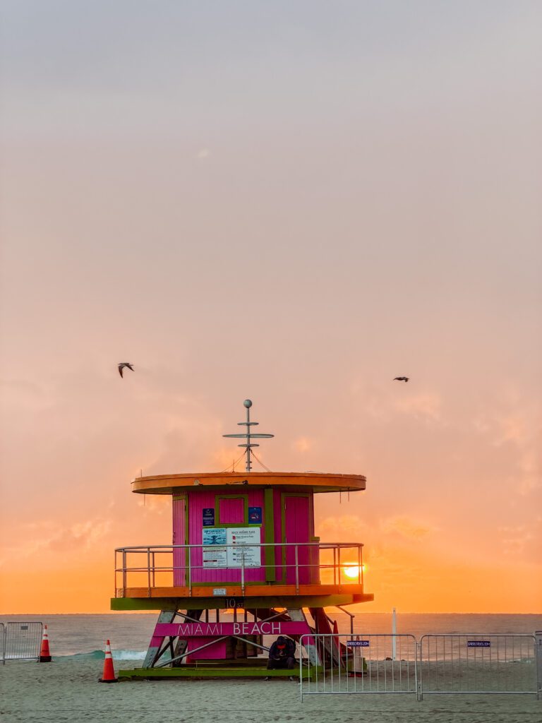 sunrise lights up the sky over miami beach