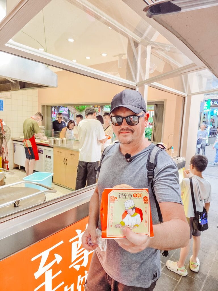 mike eating snack at the pedestrian street