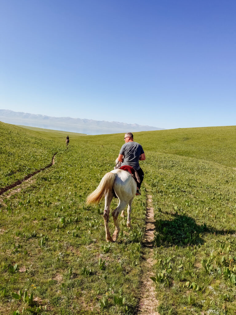 mike riding his horse at song kul