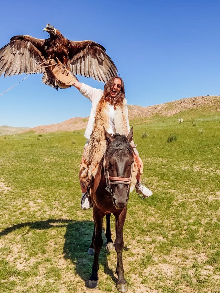 kelly at the eagle hunting demonstration in kyrgyzstan