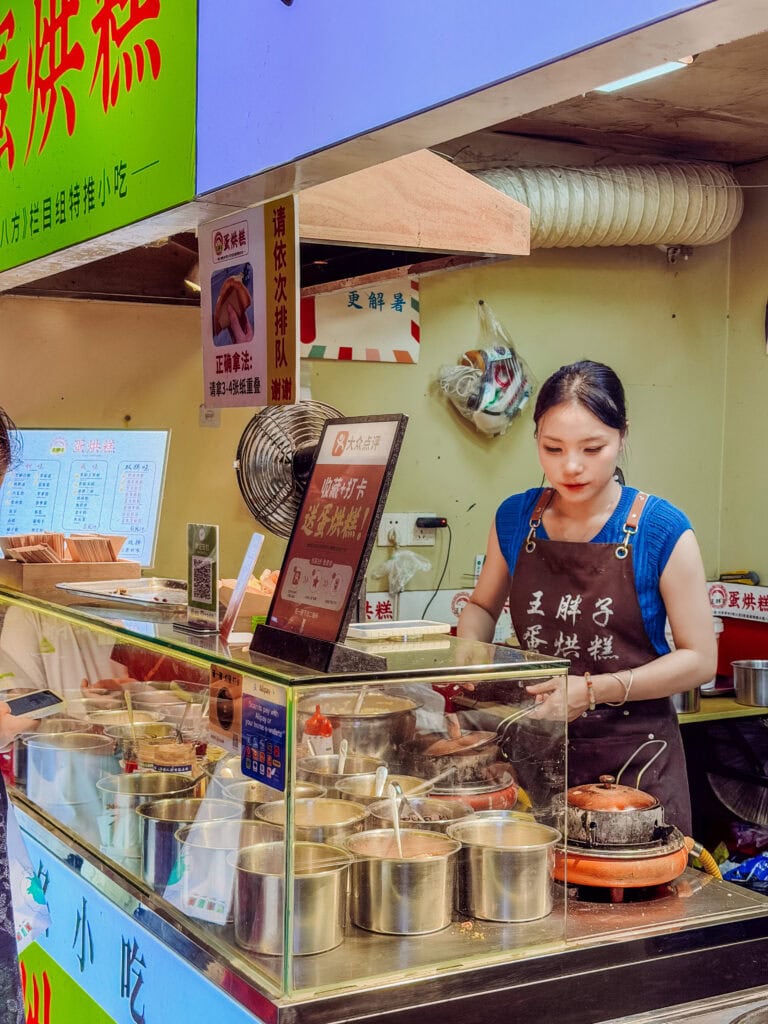 a lady making egg cakes in chengdu