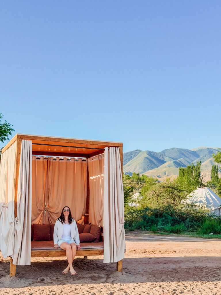 kelly sitting in lakeside cabana at Issyk-kul lake in Kyrgyzstan