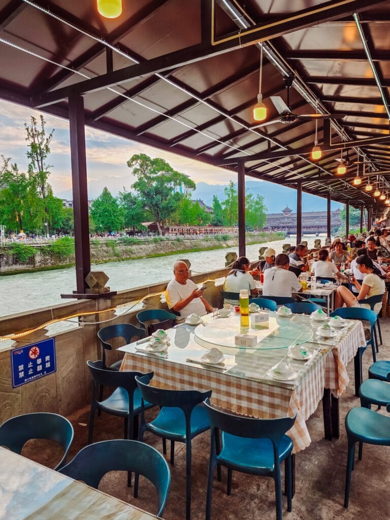 locals playing cards alongthe river